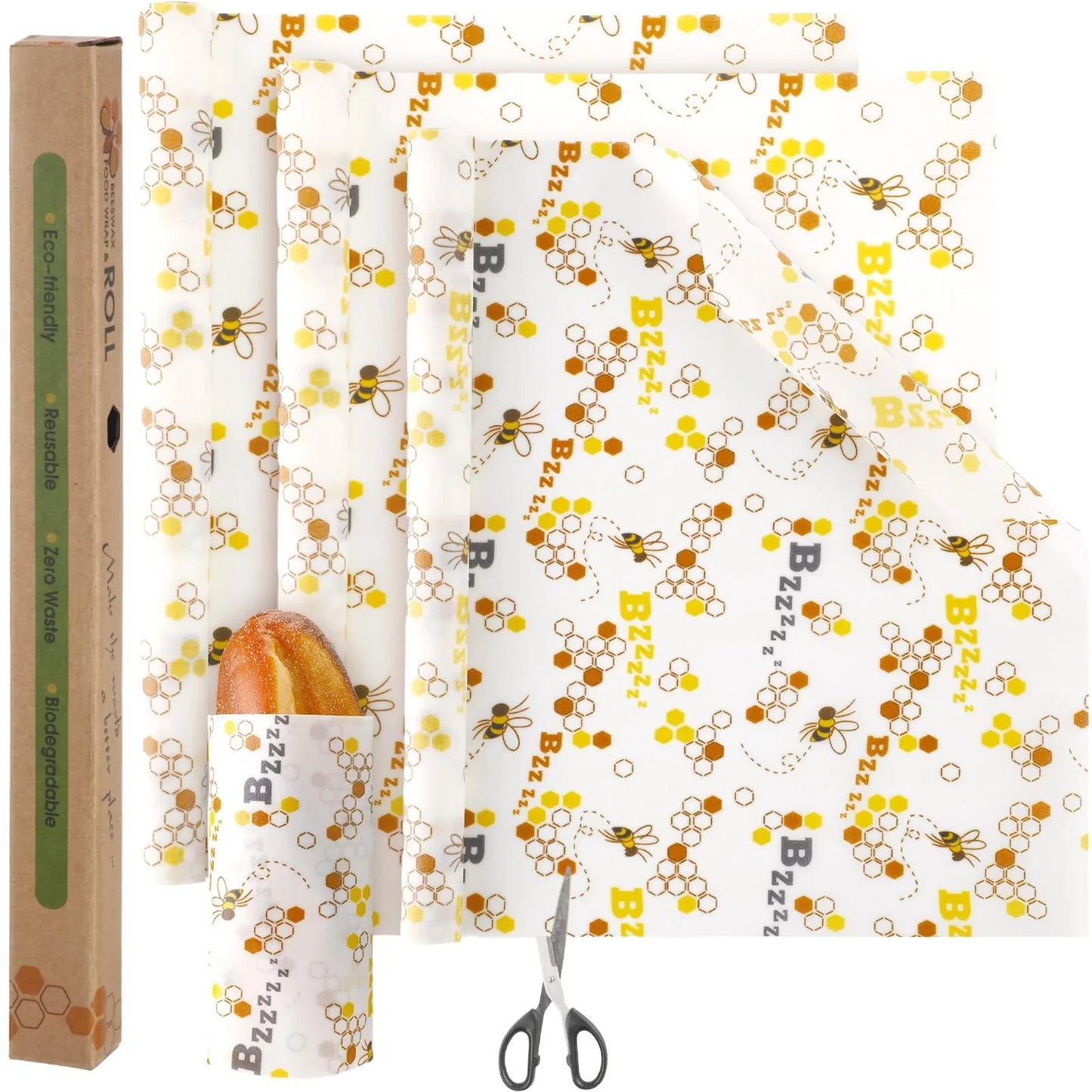 Reusable beeswax food wraps with bee and honeycomb pattern, bread loaf wrapped, scissors, eco-friendly packaging.
