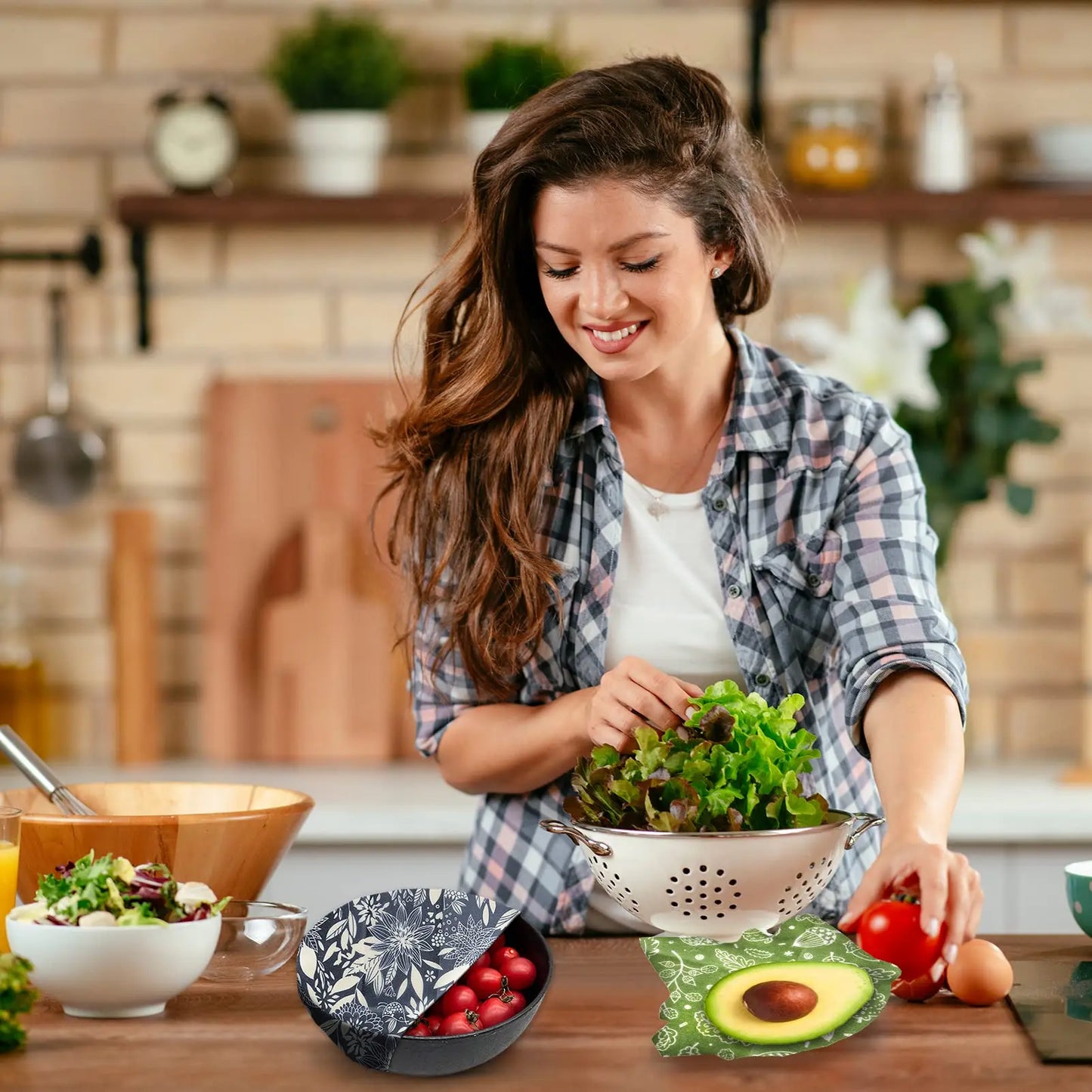 Reusable beeswax food wrap used for plastic-free kitchen storage, covering a bowl and holding an avocado.