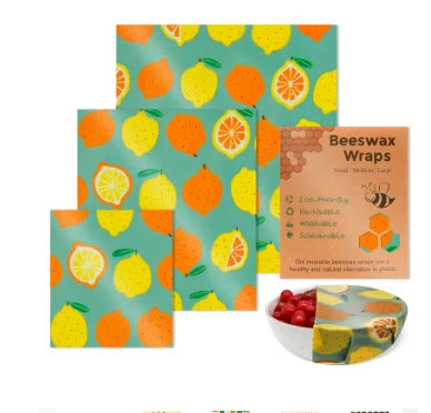 Reusable beeswax food wrap in teal with a yellow and orange citrus fruit pattern for plastic-free kitchen storage.