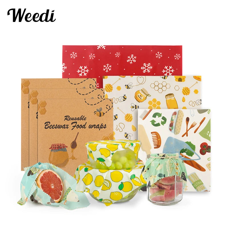 Set of reusable beeswax food wraps in various colors and patterns used for plastic-free kitchen storage.