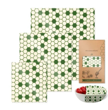 Reusable beeswax food wrap in green honeycomb pattern for plastic-free kitchen storage with packaging and bowl cover.