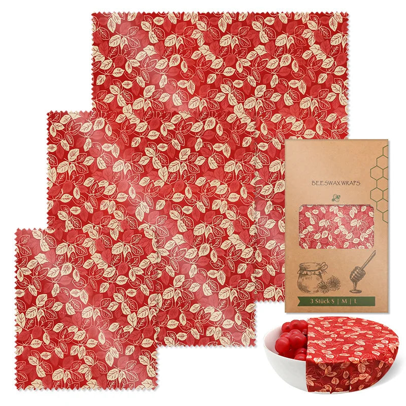 Reusable beeswax food wrap set in red and white leaf pattern, ideal for plastic-free kitchen storage.