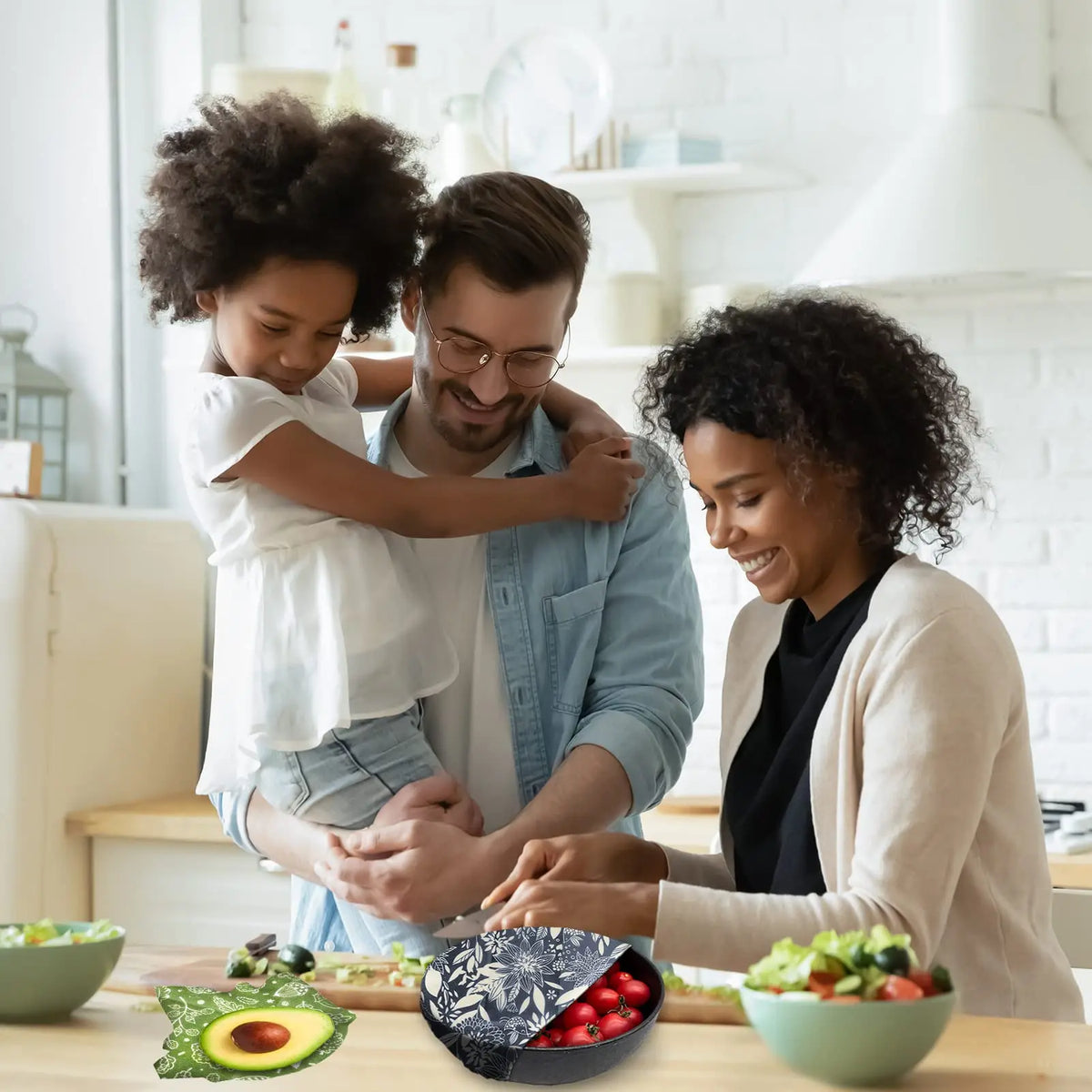 Family using reusable beeswax food wrap for plastic-free kitchen storage with a zero-waste avocado and bread wrap.