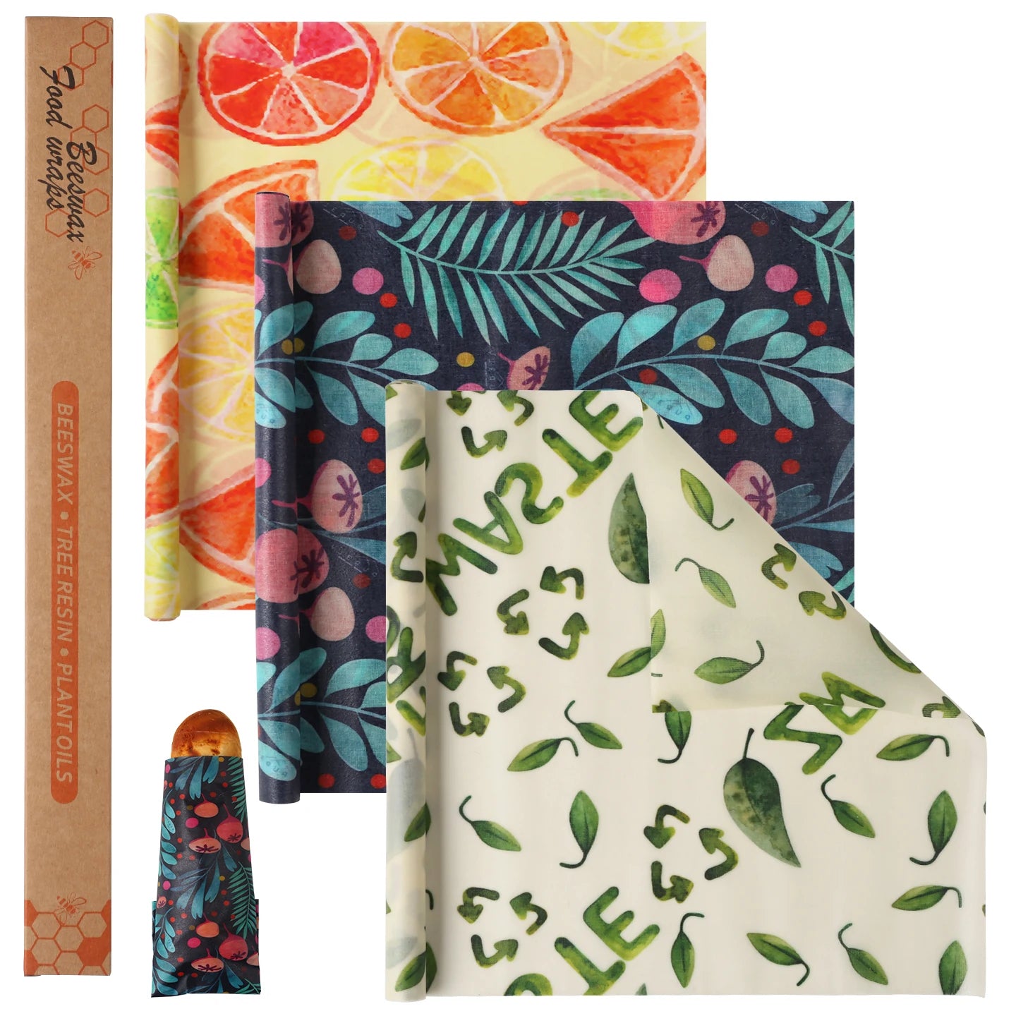 Reusable beeswax food wrap rolls in citrus, floral, and leaf patterns for plastic-free kitchen storage.