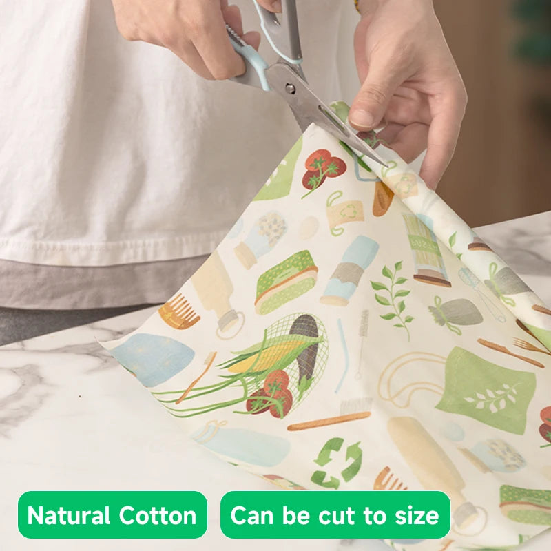 Person cutting a reusable beeswax food wrap for plastic-free kitchen storage.