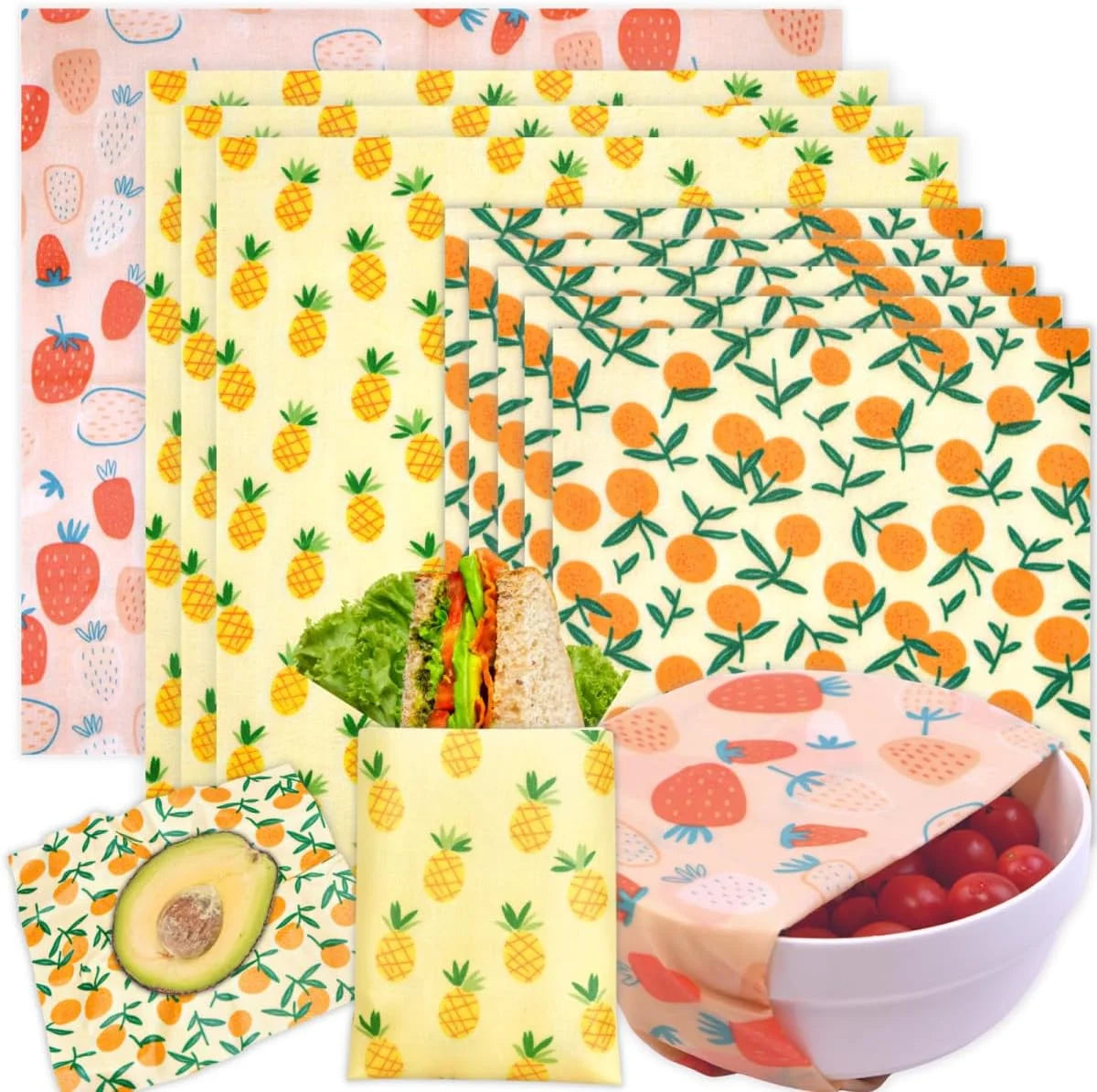 Assorted reusable beeswax food wrap for plastic-free kitchen storage, featuring strawberry, pineapple, and orange prints.