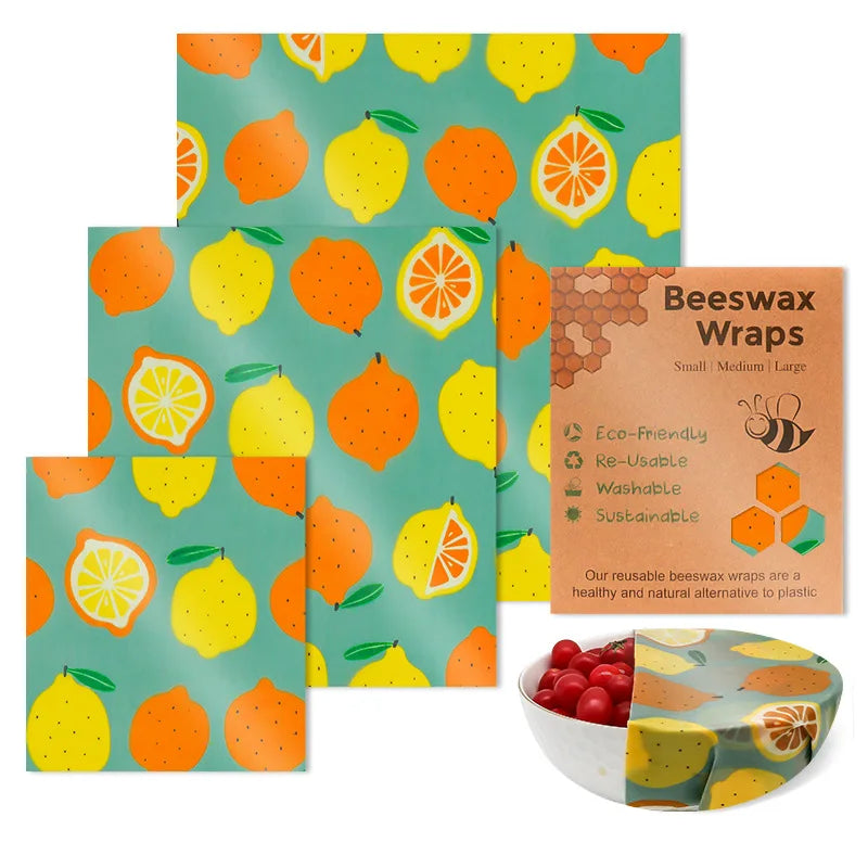 Three reusable beeswax food wraps featuring a teal, yellow, and orange citrus fruit pattern for plastic-free kitchen storage.