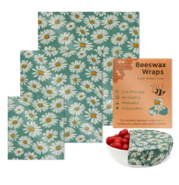 Green daisy-patterned reusable beeswax food wrap for plastic-free kitchen storage.
