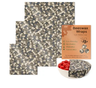 Reusable beeswax food wrap set in dark leaf pattern for plastic-free kitchen storage, covering a bowl of berries.
